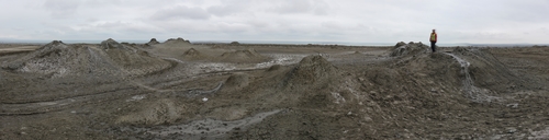 Mini mud volcanoes at the top of an inactive mud volcano near Alat, with the Caspian Sea in the background.