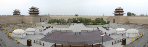 Panorama of the inner city of Jiayuguan fortress. In the foreground, where the fake yurts are, are where kitschy "military" performances are sometimes held. The two pavillions on the left sit atop the gates in the outer and inner walls guarding the fortress from the west (i.e. the western border of the Ming Dynasty, beyond which lies the vast Gobi desert), while the pavillion on the right sits atop the gate to the inner city from the east.