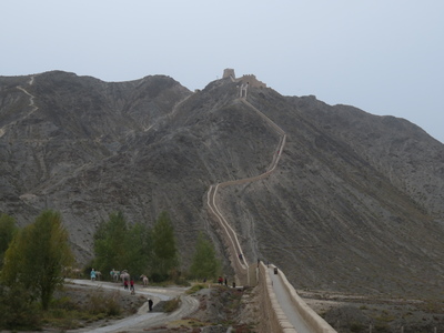 The Overhanging Great Wall, the last section of the Great Wall that extends north from Jiayuguan fortress. The wall climbs steeply up the eastern slope of the (appropriately named) Black Mountain and ends at the top.