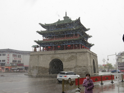Snow falling around the Bell and Drum Tower in the centre of Yongchang, on the junction of North, South, East, and West Streets