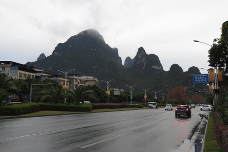 Karst mountains jutting out of the ground in between the buildings in Guilin