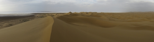 Sand dunes of the Maranjab desert and view of the Namak salt lake near Kashan