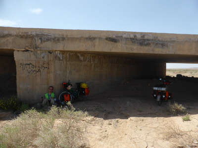 Having lunch in a drainage tunnel under the road, usually the only place to hide from the scorching desert sun, with the added advantage of hiding from people as well