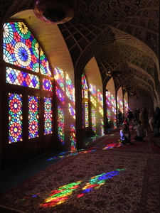 Inside the Nasir al-Mulk Mosque in Shiraz, also popularly known as the Pink Mosque, with sunlight streaming in through the colourful stained-glass mosaic windows lining the main prayer hall