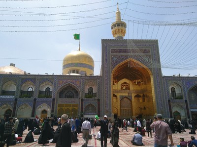 One of the central courtyards of the Holy Shrine of Imam Reza in Mashhad. The tomb of Imam Reza, the eighth Shiite Imam, is located below the golden dome to the left of the iwan, and can be seen through the windows in front. He is buried underground below the tomb.