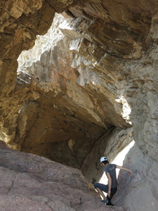 Climbing through one of the cave-wombs on the Sulaiman Too mountain in Osh, where pilgrims seek fertility help from the holy mountain