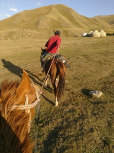 Horse trekking to Song-Kul lake - Hannah's horse being dragged into the yurt camp in Kelimche valley where we would stay for the night