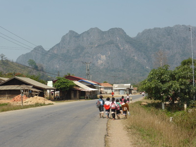 Schoolchildren walking on the road, between Lak Sao and Ban Nahin