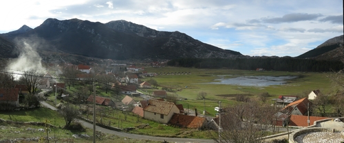 Njeguši village around the Njeguši field, flooded from the heavy rains from the previous few days, surrounded by mountains