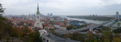 View of Bratislava old town from the castle, with St. Martin's Cathedral and the Bridge of the Slovak National Uprising across the Danube river.