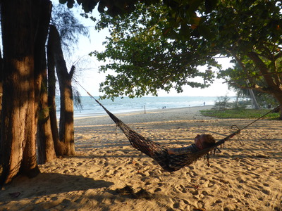 Heiko relaxing in a hammock outside our beachfront bungalow at Ban Suan Luang