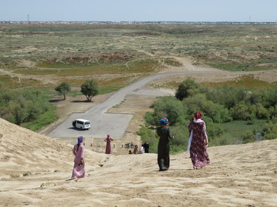 Local tourists climbing down the remains of the walls of the Erk Gala, the oldest part of ancient Merv, dating from the 7th century BC. Most of the women we saw in the country wear the traditional dress and headdress similar to the women in this photo.
