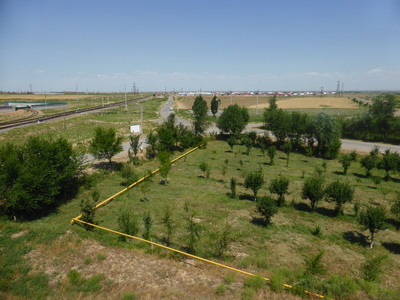 Typical landscape of the Bukhara region - blue skies, white clouds, and green land, similar to the colours of the Uzbekistan flag