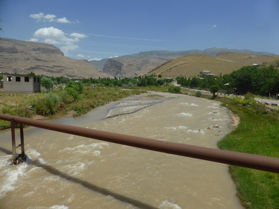 The Machay river passing through the village of Derbent, in the Gissar mountain range on the way to Boysun. In the background the tops of the cliff edges of the Machay canyon can be seen, named after the river that passes through it.