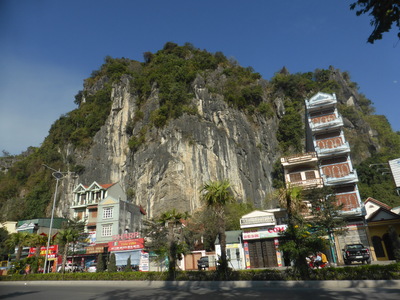 Karst mountains popping up behind the buildings between Cam Pha and Halong