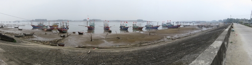 Fishing boats moored on the shore, on the way from Thanh Hoa to Vinh